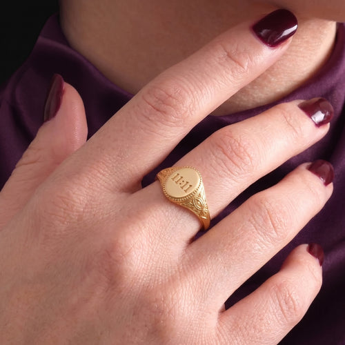 11:11 signet ring worn on the ring finger
