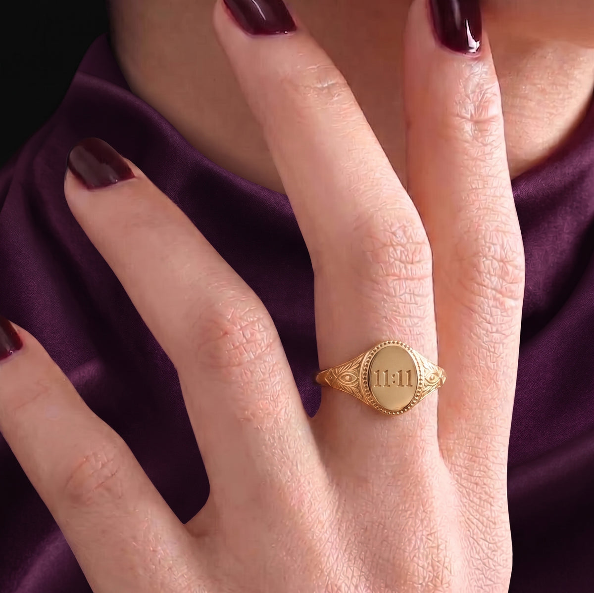 11:11 signet ring worn, front view of the engraved face