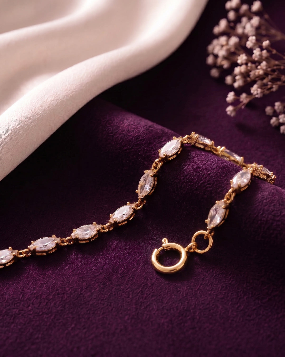 Marquise cubic zirconia bracelet draped over purple velvet, showing the spring ring clasp