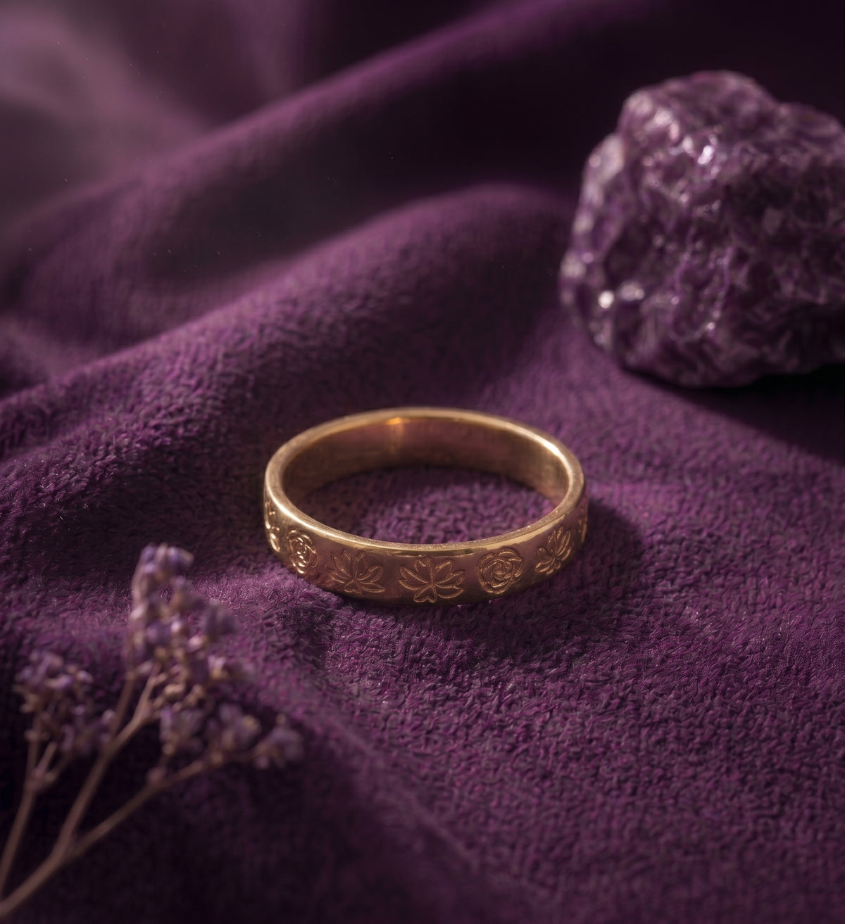 Birth flower ring on purple velvet, showing the engraved flowers