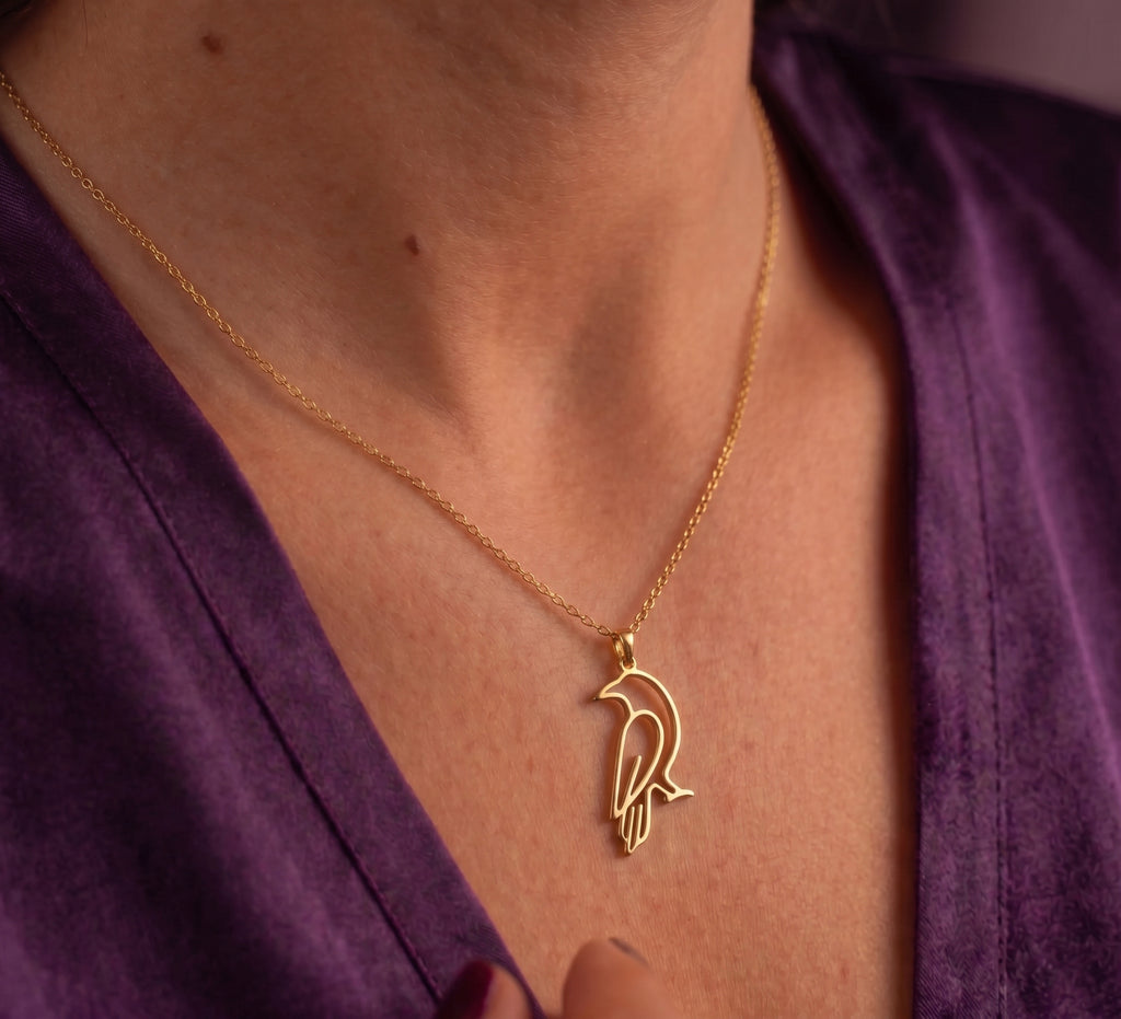 Crow necklace worn, close-up