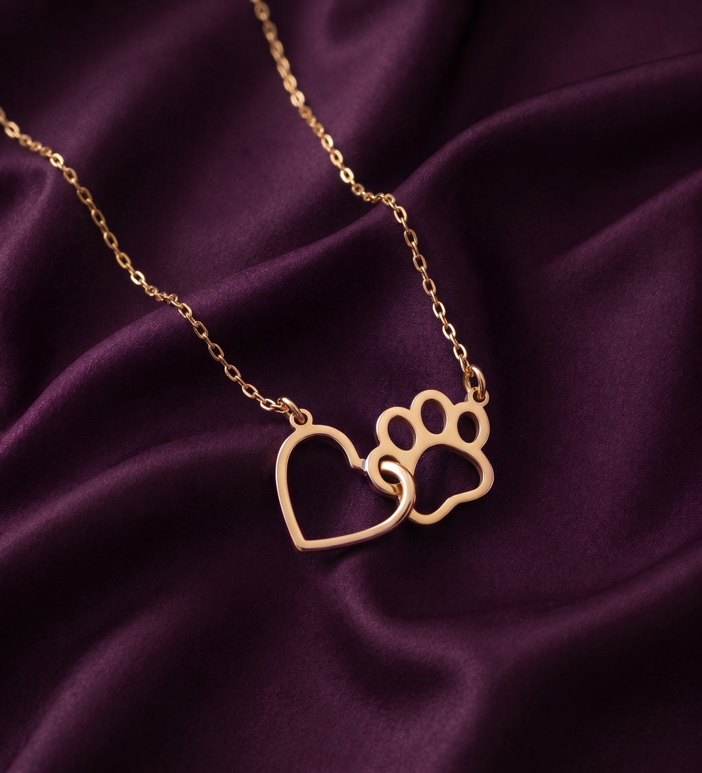 Close-up of the linked heart and paw print on purple satin