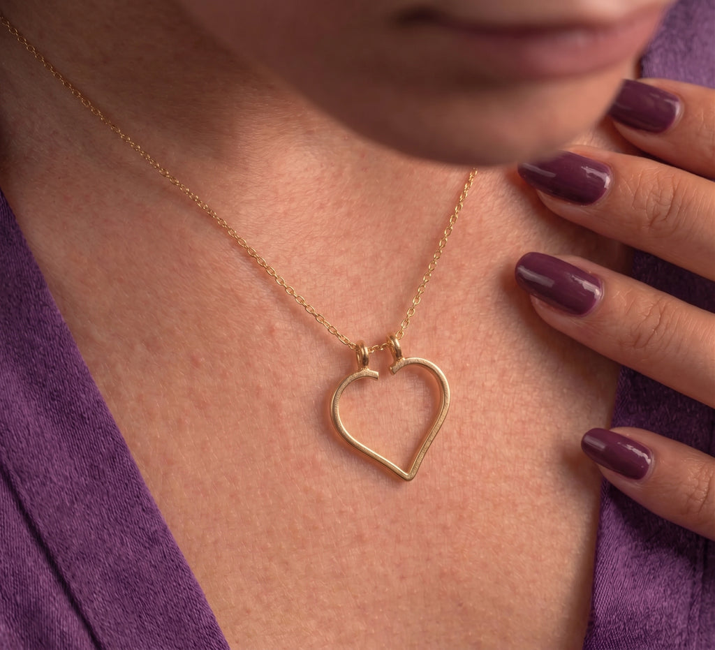 Close-up of the open heart pendant worn