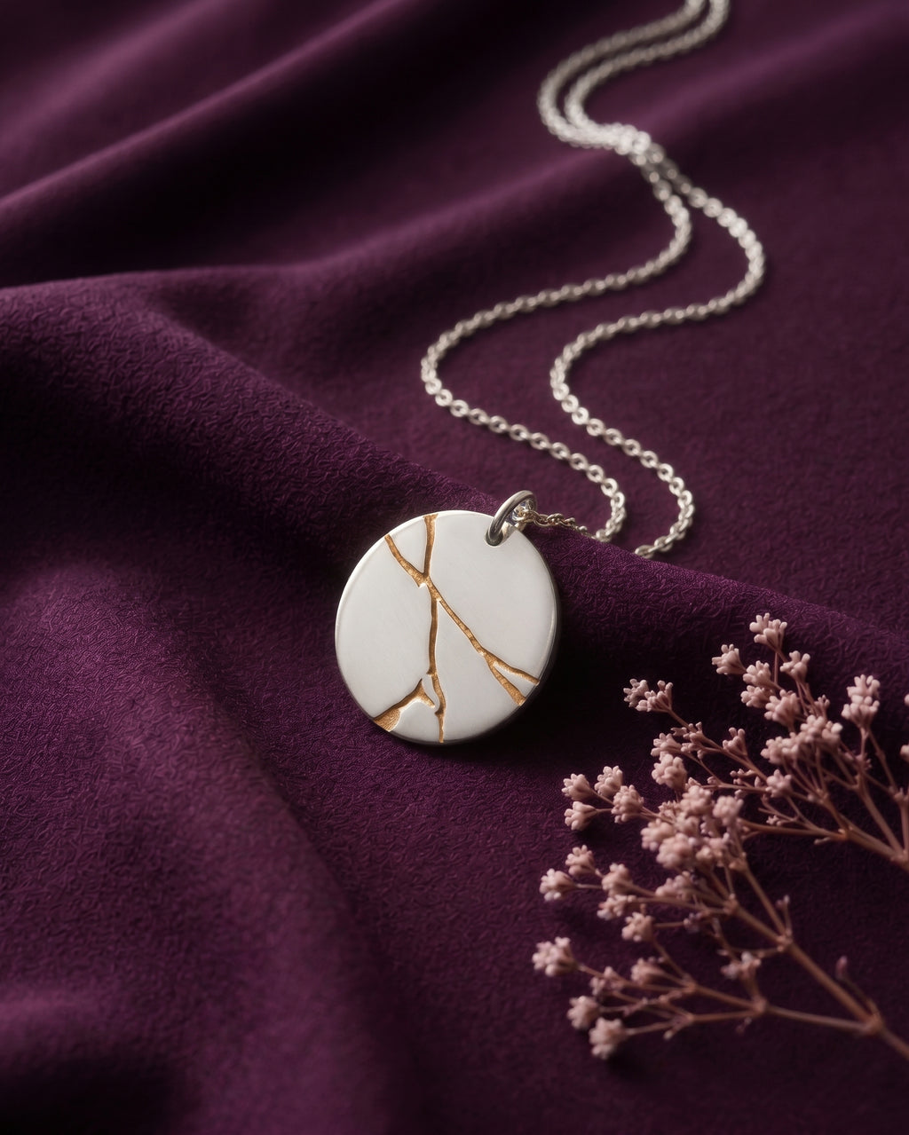 Silver tone kintsugi disc necklace with gold tone lines
