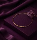 Morse code bracelet with beads and bars displayed on a plum box with dried flowers