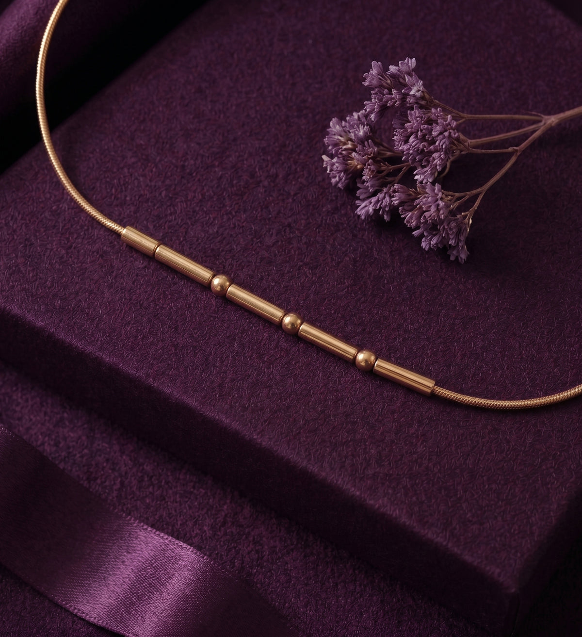 Close-up of the beads and bars of the Morse code bracelet on velvet