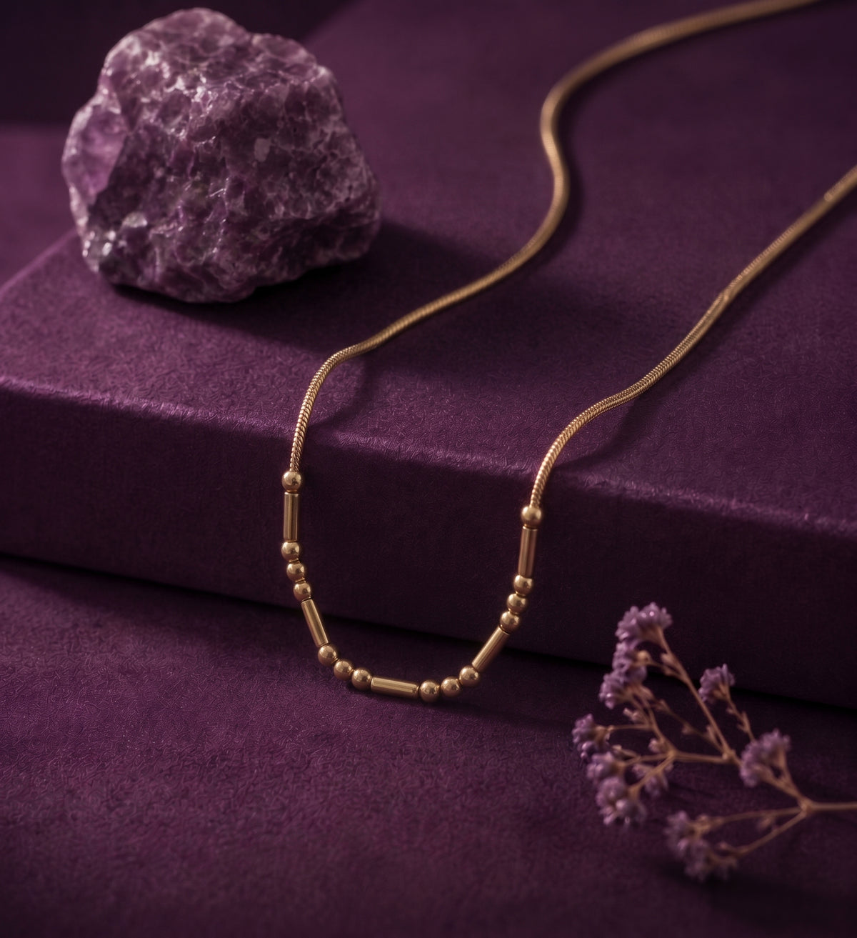 Morse code necklace on purple velvet with an amethyst stone