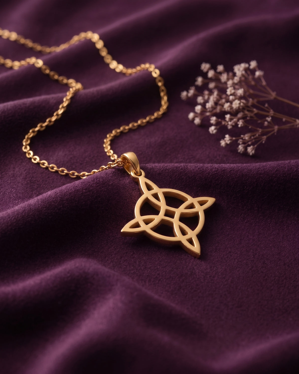Witch's knot necklace on purple velvet with dried flowers