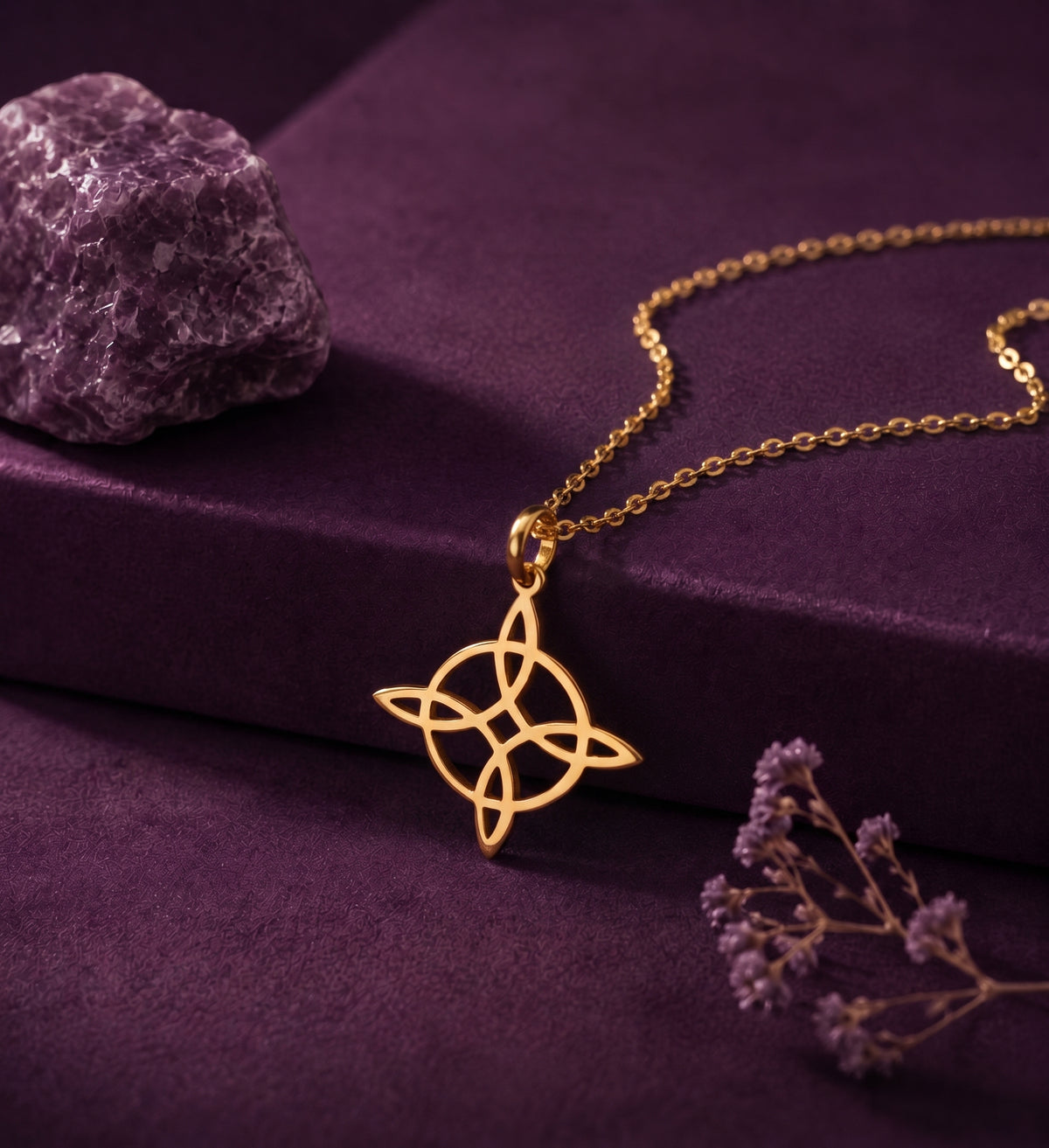 Witch's knot necklace on a plum box beside an amethyst stone